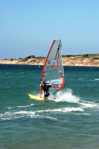 Uomo windsurf al largo della spiaggia di Valdevaqueros, Tarifa, Spagna . — Foto Stock