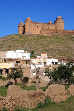 Tepedeki şatonun manzarası ön planda kasaba binaları, La Calahorra, İspanya.