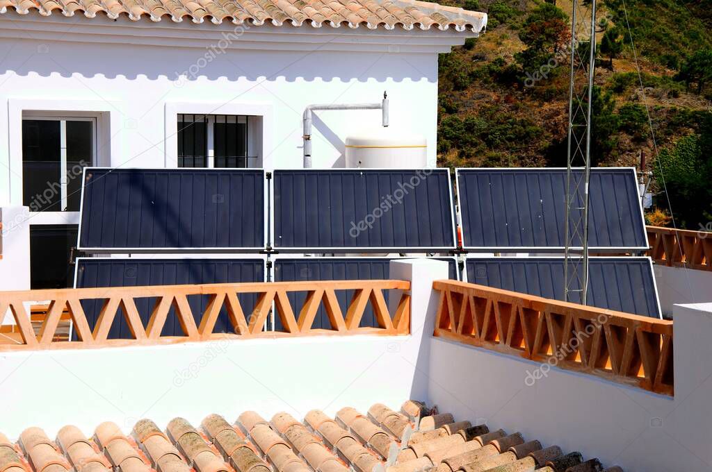 Solar panels on a townhouse roof in the village centre, Benahavis, Costa del Sol, Malaga Province, Andalucia, Spain, Europe.