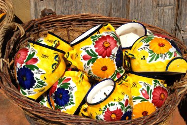 Ceramic pots for sale in wicker baskets outside a village shop, Frigiliana, Malaga Province, Andalucia, Spain, Europe. clipart