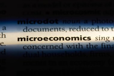 microeconomics word in a dictionary. microeconomics concept. clipart