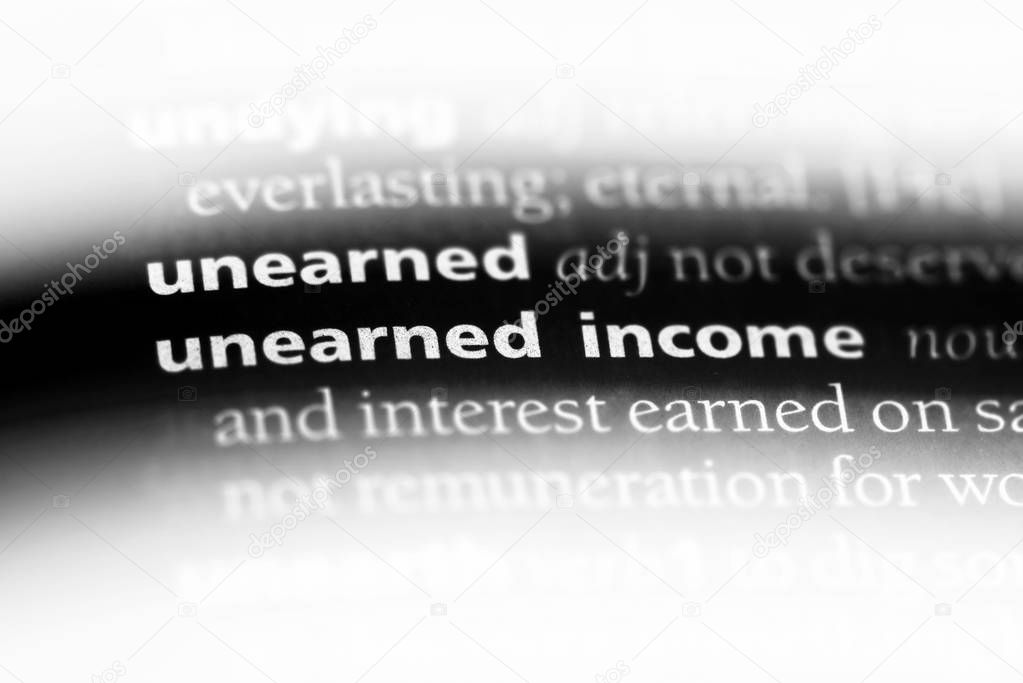 unearned income word in a dictionary. unearned income concept.