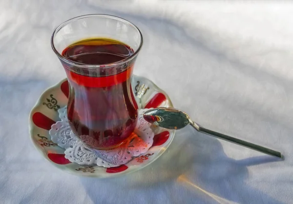 traditional turkish tea with tea cup, saucer and spoon