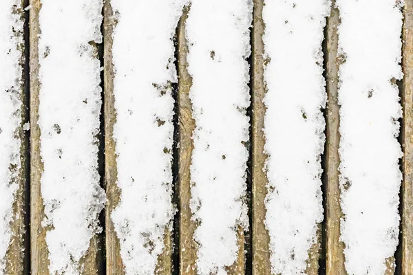 自然の中の木製のベンチで雪が降る — ストック写真