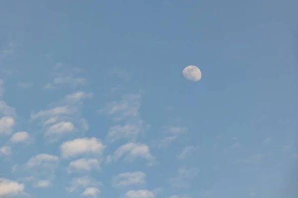 moon and clouds in blue hour