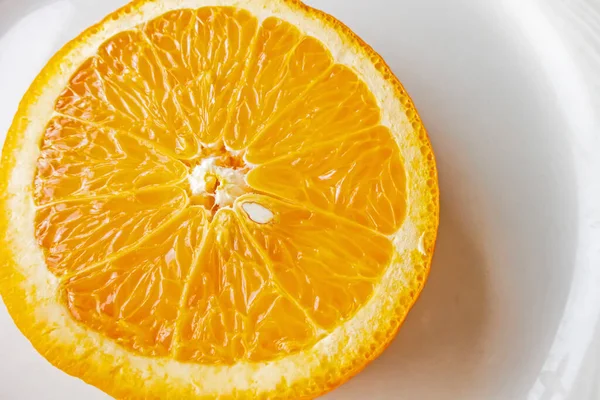 slices of orange on white plate background