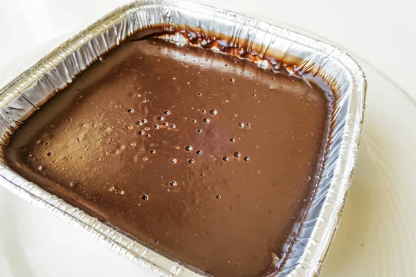 chocolate pudding in aluminum bowl in restaurant