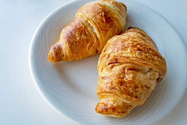 France\'s national food croissant on a white plate