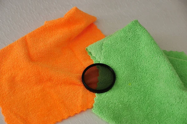 Cleaning the camera lens and filter glasses with microfiber cloth, lens and filter glass maintenance,
