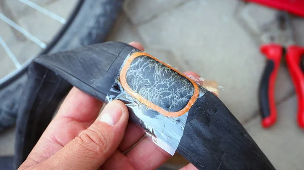 make bicycle tire repair, a person is repairing a puncture bicycle inner tubes,