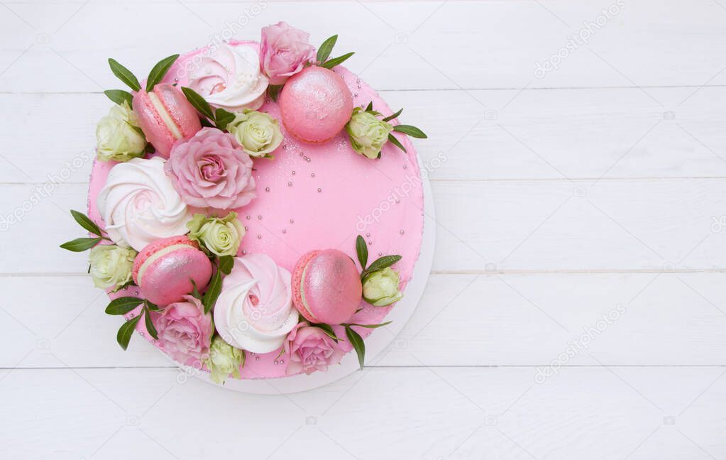 Modern pink cake with fresh roses and macaroons. Concept for Wedding , St. Valentine's Day, Mother's Day, Birthday Cake. 