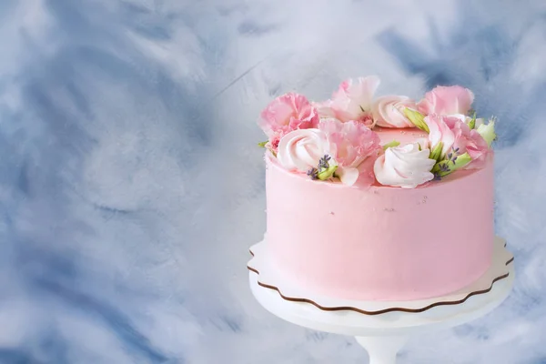 Pink cake. Meringues and pink flowers on the top of cake . Concept for Wedding , St. Valentine\'s Day, Mother\'s Day, Birthday Cake. Beautiful cake on stand