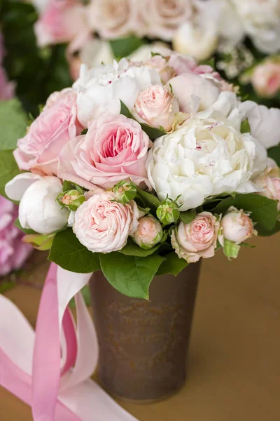 Brides bouquet with peony roses and ribbon