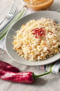 Spicy parboiled rice with carrots, yellow zucchini and chilli peppers clipart