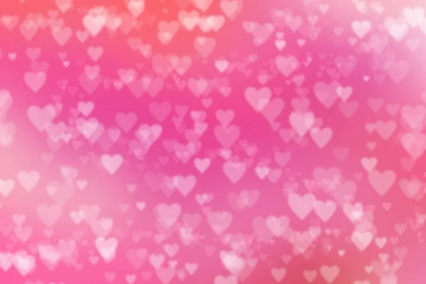 Blurred heart shaped bokeh on pastel pink background. Valentine\'s day and love concept