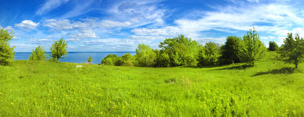 Beautiful panorama of Kaniv Reservoir shore, Ukraine, in sunny day with bright cloudy sky