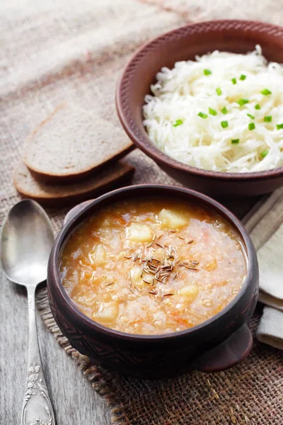 Kapustnyak - traditional Ukrainian winter soup with sauerkraut and millet, obligatory dish on the Christmas Eve table — Stock Image Kapustnyak - traditional Ukrainian winter soup with sauerkraut and millet, obligatory dish on the Christmas Eve table Stock Photo