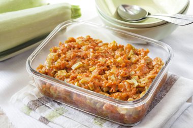 Bir kare cam çanak havuç ve domates ile squash güveç