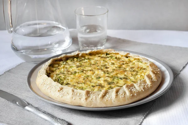 Tart with eggs and green onions on a plate — Stock Photo, Image