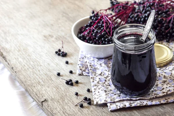 Homemade black elderberry syrup in glass jar — Stock Photo, Image