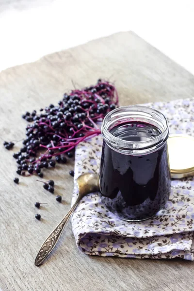 Homemade black elderberry syrup in glass jar — Stock Photo, Image