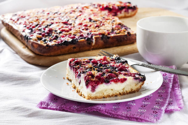 Tasty breakfast. Delicious pie with assorted berries and cottage cheese and a cup of tea