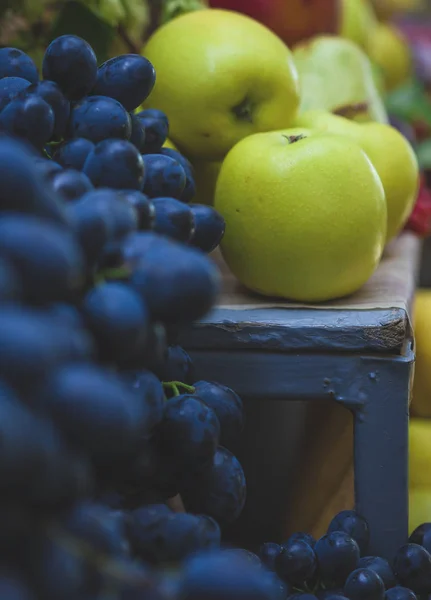 Beautiful fruit composition with blue organic grapes and yellow apples. Fruit bacground.