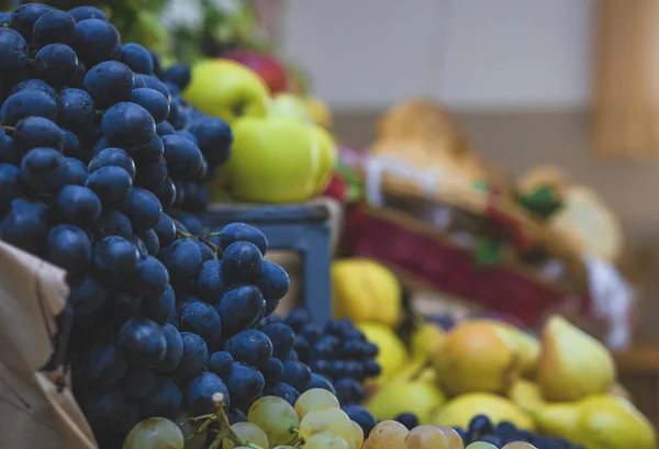 Beautiful fruit composition with blue organic grapes and yellow apples. Fruit bacground.