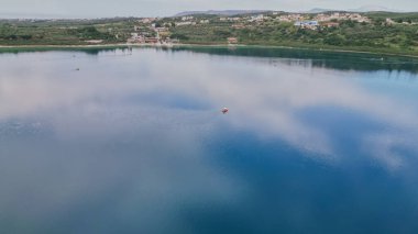 Family enjoying summer activity on a pedal boat at freshwater Kournas Lake near Georgioupoli in Crete, popular tourist destination with scenic nature..