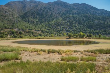 Yunanistan 'ın Girit kentindeki Beyaz Dağlar' daki Omalos köyünde bir gölün kuruması sırasında gözlemlenen iklim değişikliği sorunu, güneşli gökyüzü altındaki çevre sorunlarını vurguluyor