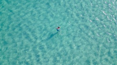 Young man snorkeling with mask in crystal clear turquoise sea water, enjoying summer vacation, underwater adventure and outdoor leisure activity