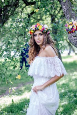 Beyaz gelinlik ve çiçek çelengi içinde güzel bir gelin..