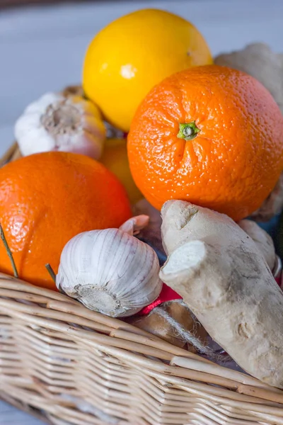 Citrus fruits, garlic and ginger root on basket