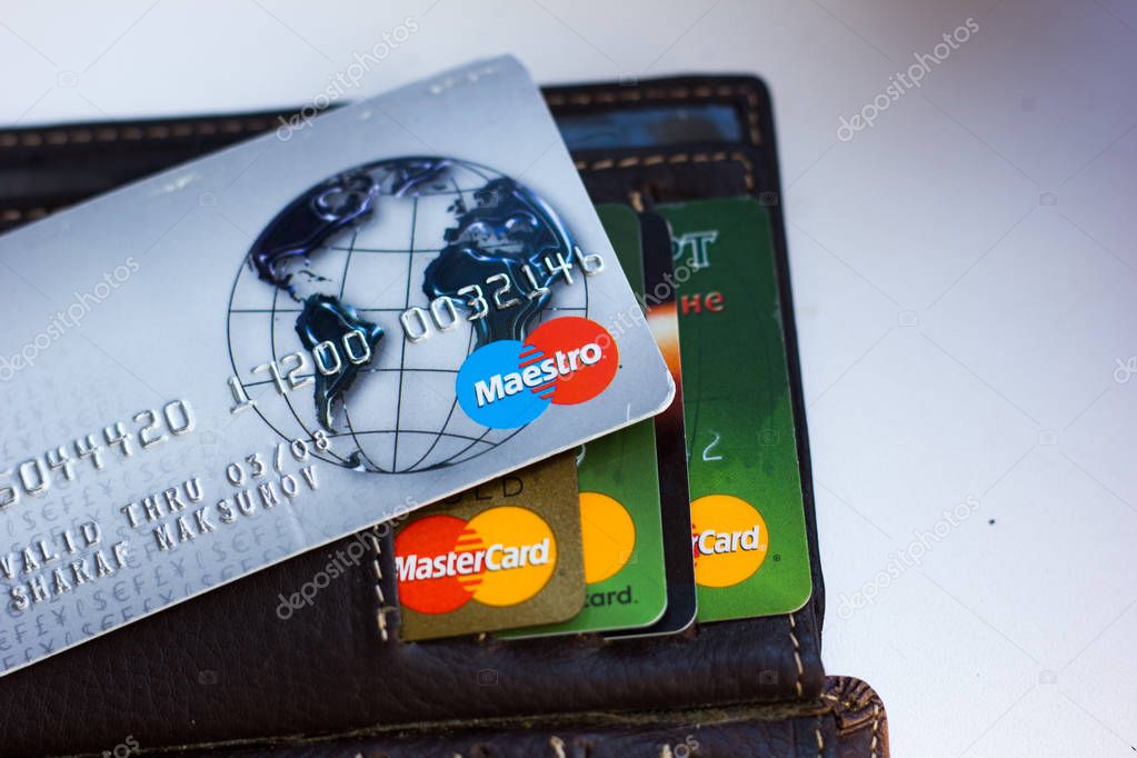 Ryazan, Russia - February 27, 2018: Credit card of Maestro brand over the leather wallet and number of cards