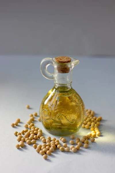 Natural and organic soybean oil with soy beans around it