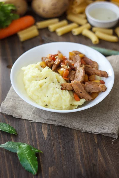 Soy meat with potato puree over kitchen table.