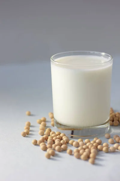 Soybean milk with soy beans around it.