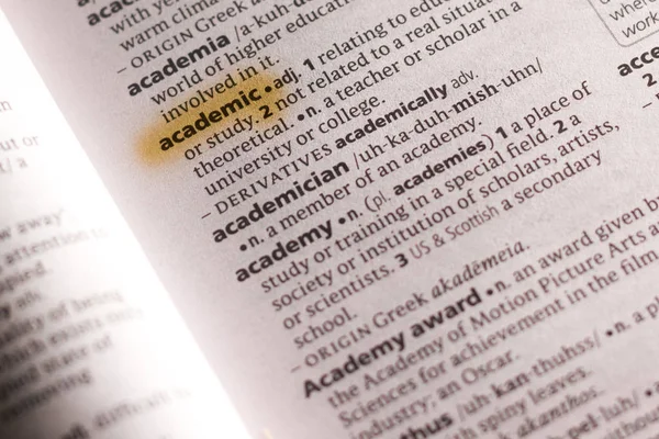The word or phrase Academic in a dictionary highlighted with marker.
