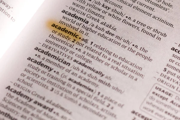 The word or phrase Academic in a dictionary highlighted with marker.