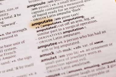 The word or phrase Amputate in a dictionary highlighted with marker.