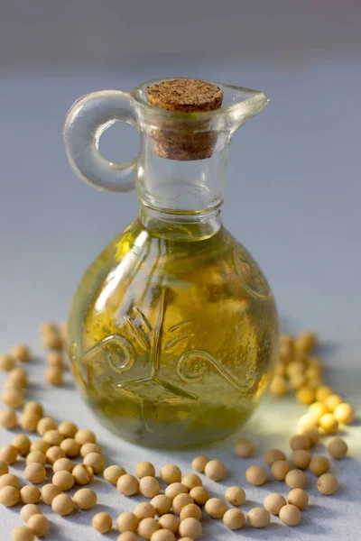 Natural and organic soybean oil with soy beans around it
