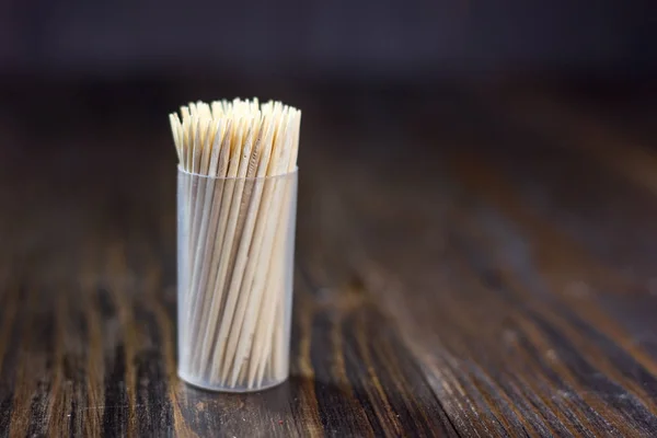 Babmoo dental tooth picks on a dark wooden table. — Stock Photo, Image