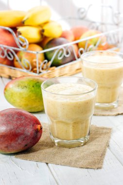 Beyaz masa üzerinde bir bardak taze mango smoothie