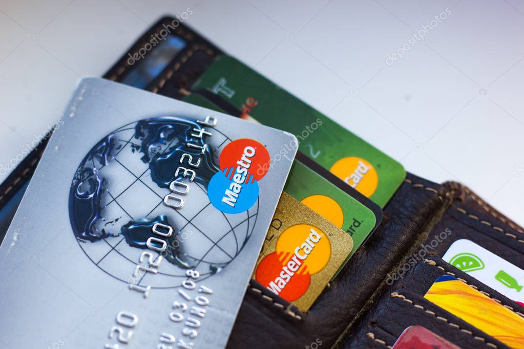 Ryazan, Russia - February 27, 2018: Credit card of Maestro brand over the leather wallet and number of cards