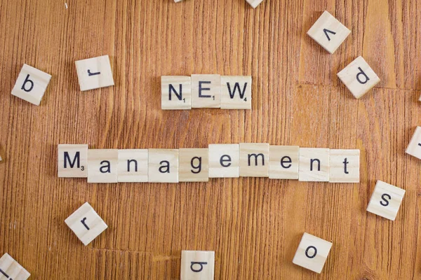 Word or phrase New Management made with scrabble letters, great image for your needs.