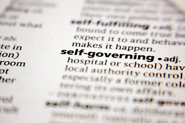 Word or phrase self-governing in a dictionary. — Stock Photo, Image