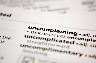 Word or phrase uncomplaining in a dictionary.