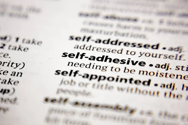 Word or phrase self-adhesive in a dictionary. — Stock Photo, Image