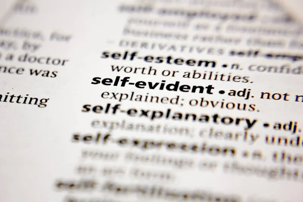 Word or phrase self-evident in a dictionary. — Stock Photo, Image