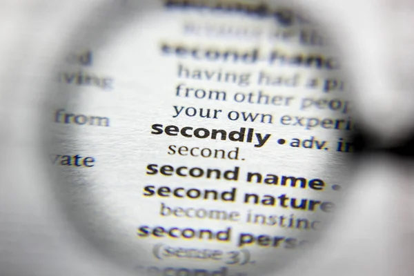 The word or phrase Secondly in a dictionary. — Stock Photo, Image